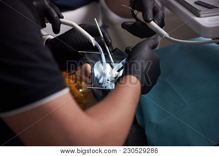 Close-up Process Of Male Professional Dentist Surgeon Performing Operation Install Dental Implant Te