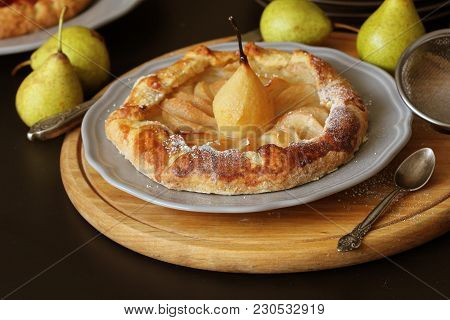 Homemade Galette With Pears On Black Background. French Cuisine - Breton Galette. Sweet Open Pie .