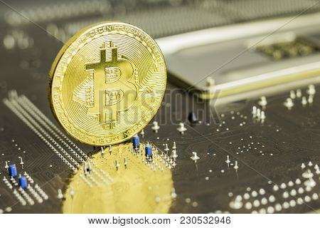 Bitcoin Coin On The Back Of A Pc Motherboard, Symbolizing It's A Virtual Money.