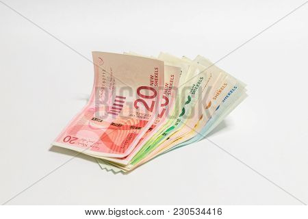 Israeli Money Stack Of New Israeli Banknotes Of Different Value In Shekels (nis) Isolated On A White
