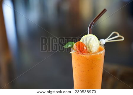 Fresh Mixed Tropical Vegetable And Fruit Smoothie Juice Decorated With  Fresh Tomato And Pice Of Lim
