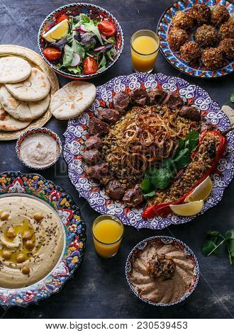 Middle Eastern Or Arabic Dishes And Assorted Meze On A Dark Background. Meat Kebab, Falafel, Baba Gh
