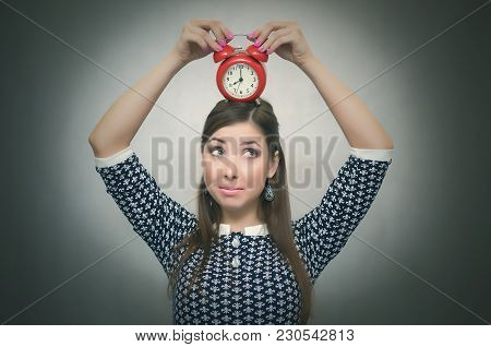 Guilty Look Woman Holding In Hands Alarm Clock And Hides Her Eyes. Latecomer Student Or Emloyee. Be 