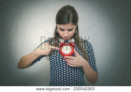 Overslept Shocked Woman Holding In Hand A Red Alarm Clock. Be Late At Work Or School. Oversleep. Lat