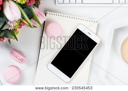 Lady Bloggers Work Desk With Pink Flowers And Macaron Cakes On White Table Background, Feminine Home