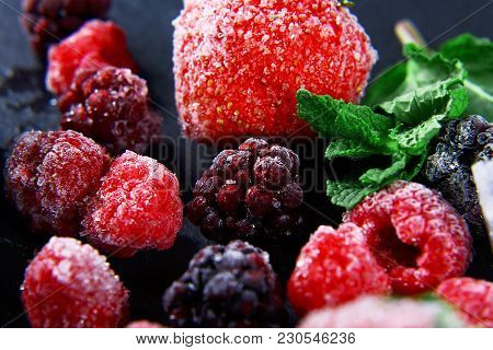 Macro Frozen Raspberry, Blac Kberry, Strawberries Mint Leaves, Pieces Of Ice On A Black Shale Board,