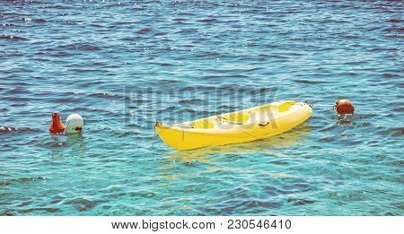 Anchored Yellow Kayak In Maslinica, Solta Island, Croatia. Summer Vacation Destination. Retro Photo 