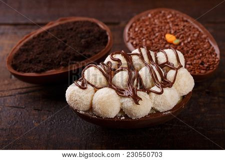 Chocolate Egg Ith Filling For Easter On Wooden Background