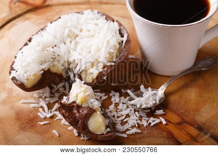 Chocolate Egg With Filling For Easter On Wooden Background