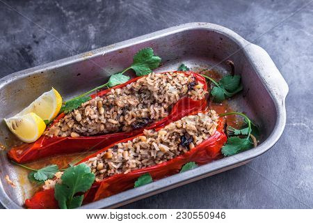 Ramiro Peppers Stuffed With Rice In Iron Cooking Pot On Dark Rustic Kitchen Table Background, Top Vi
