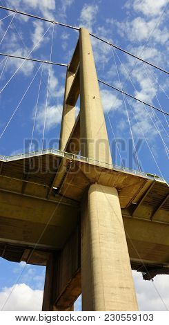 One End Of The Humber Bridge Looking Up From Underneath With Blue Sky And White Clouds Behind
