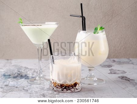 Group Of Cocktails On A Restaurant Background: Pina Colada, Coffee Cocktail Black Russian, Liquor In