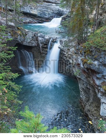 Two Of Many Aqua Colored Falls In Johnstone Canyon, Banff National Park.
