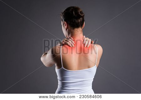 Neck Pain, Woman With Backache On Gray Background, Studio Shot