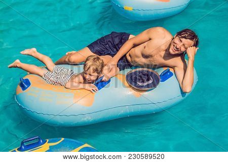 Father And Son Have Fun At The Water Park.