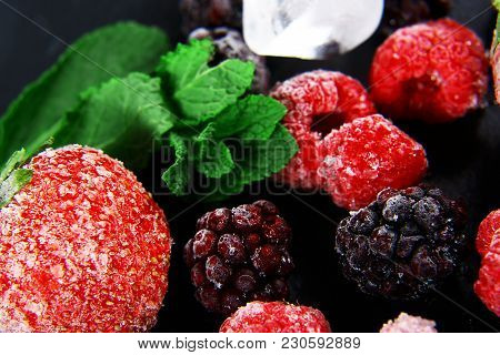 Macro Frozen Raspberry, Kberry, Strawberries Mint Leaves, Pieces Of Ice On A Black Shale Board, Froz