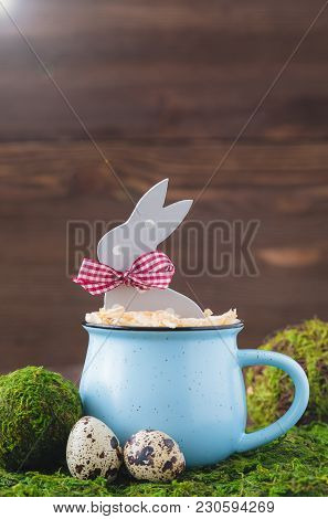 Wooden Polka Dot Grey Rabbit In A Blue Cup On The Grass Background, Easter Postcard Concept, Toned