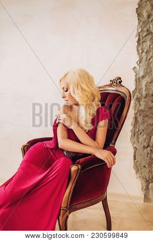 Portrait Of Beautiful Young Woman In Red Dress With Makeup In Fashion Clothes