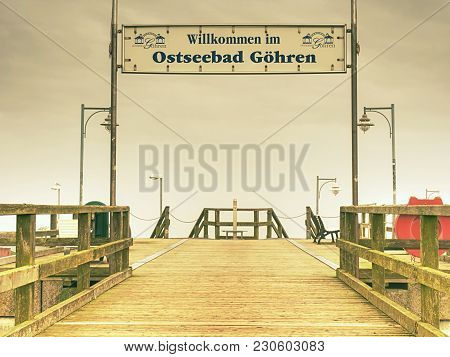 Pier Sign In Sea Spa Town Goehren, Island Of Ruegen, Germany.  Autumnal Misty Morning, Out Of Season