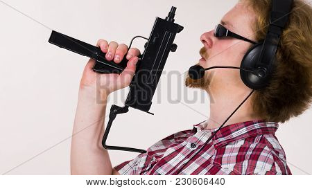 Nerd Geek Young Adult Man Playing On The Video Console Holding Gun Wearing Headphones With Microphon