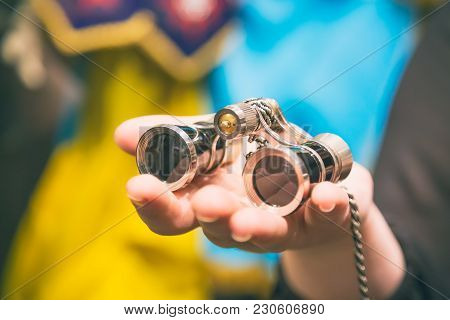 Theater Concept. Vintage Binoculars In Female Hand In Theatre Or Opera.
