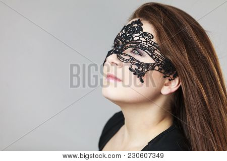 Pretty Mysterious Woman Wearing Black Eye Lace Mask Having Tousled Windblown Long Brown Hair.