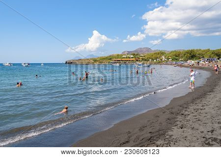 Vulcano Island, Italy - August 22, 2017: People Relax On The Black Volcanic Beach On Vulcano Island.