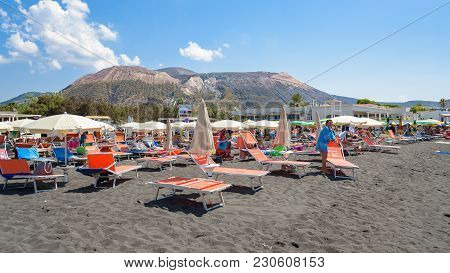 Vulcano Island, Italy - August 22, 2017: People Relax On The Black Volcanic Beach On Vulcano Island.