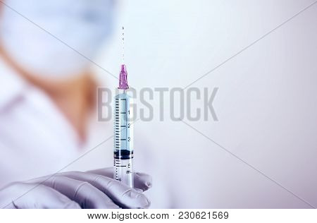 Close Up Medical Injection Syringe In Hand Of  Doctor , Medical Science Concept.