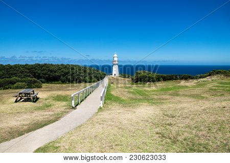 Cape Otway Lighthouse In Grasslandpark With Bench And Overlook At The Ocean At The Great Ocean Road,