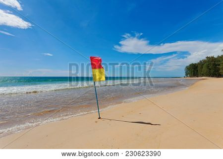 Red yellow warning flag at beach. Phuket, Thailand. 