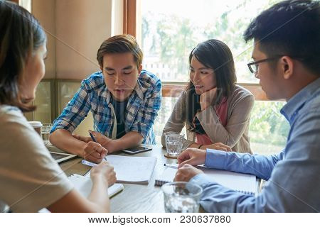 Vietnamese Young Man Explainig Homework To His Fellow Students