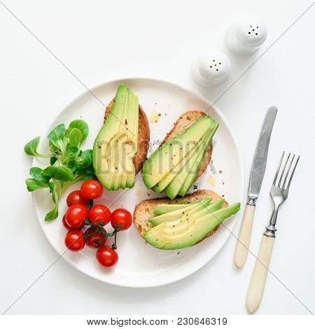 Avocado Toasts, Cherry Tomatoes And Salad On White Plate, Top View, Square Crop. Healthy Lifestyle, 