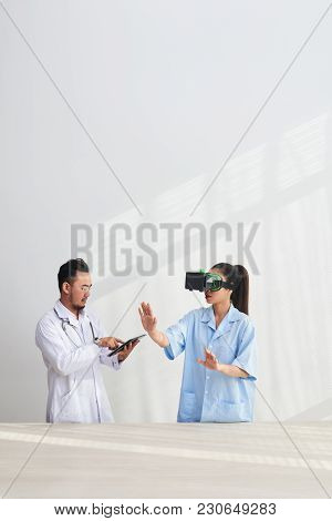 Doctor And Nurse With Headset And Digital Tablet Testing Vr Simulator Application