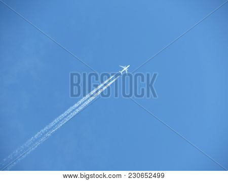 Jet Airplane With Contrail. Trace Of The High Flying Plane In The Blue Sky