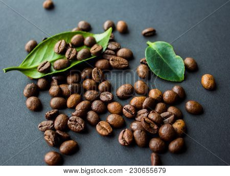 Coffe Beans And Green Leaf On Black Background