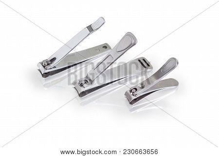 Three Different Nail Clipper In The Compound Lever Style Made Of Stainless Steel On A Matte Reflecti