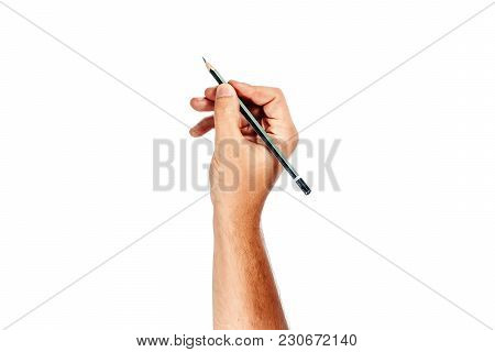 A Man's Hand Holds A Black Pencil On A White Background, Isolate.