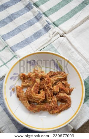 Roman-style Tripe With Tomato Sauce In A Dish On Some Colored Napkins