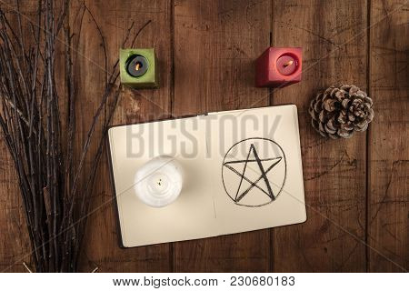 An Overhead Photo Of An Open Grimoire, Candles, A Pine Cone, And A Handmade Broom. Wiccan Ritual Obj