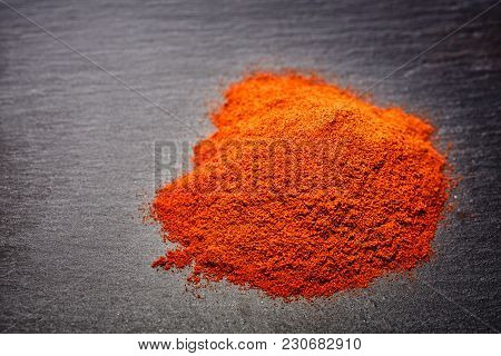 Red Ground Paprika Isolated On Dark Grey Background, Shallow Depth Of Field, Top View, Close-up, Mac
