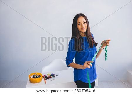 Portrait Woman - Clothes Designer, With Measuretape In Her Hand At Workshop