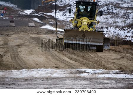Motor Grader With A Blade Performs The Layout Of A Road Crushed Stone Gravel Base