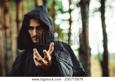 The Black Monk Pointing His Finger In The Woods