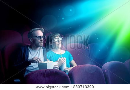 Teenager couple cuddling and watching the climax part of the movie