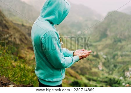 Man Explorer Holding Compass And Find Path In Mountainous Terrain On Santo Antao Island. Cape Verde.