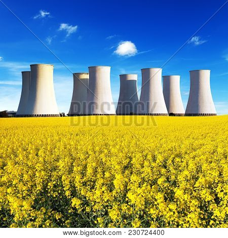 Panoramic View Of Nuclear Power Plant Jaslovske Bohunice With Golden Flowering Field Of Rapeseed - S
