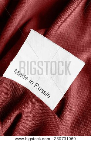 Clothes Label Lettered Made In Russia On Red Sain Background Closeup