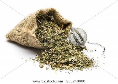 Green Tea Mixture In Juta Bag With Infuser On White Background