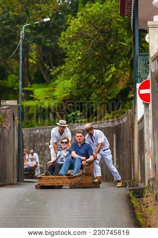 FUNCHAL, MADEIRA - SEPTEMBER 19: Traditional downhill sledge trip on September 19, 2016 in Madeira, Portugal.
